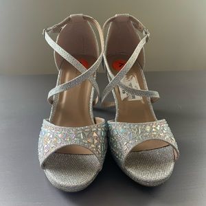 Delicacy heels. Silver glitter and gems. Brand New. Never worn. Size 7